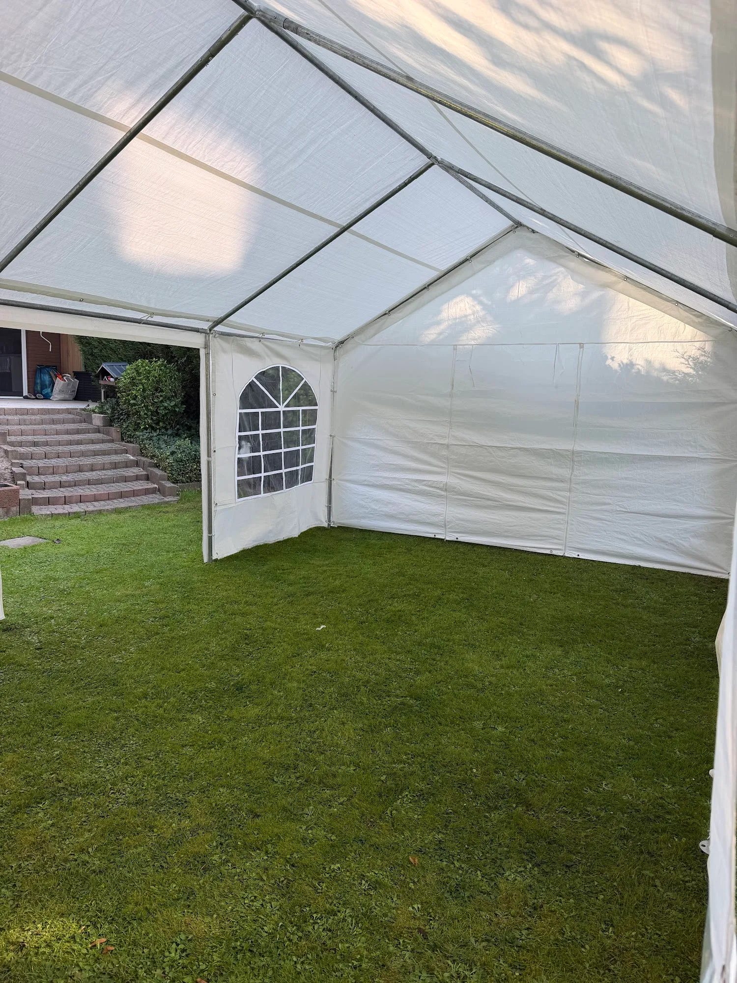 Weißes Partyzelt aufgebaut im Garten